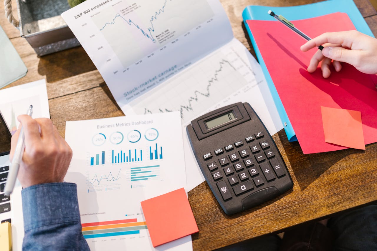 pexels-photo-7414218-1 Financial analysis and planning tools with graphs and calculator on a table.